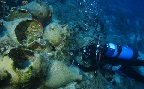 Diver measures amphoras